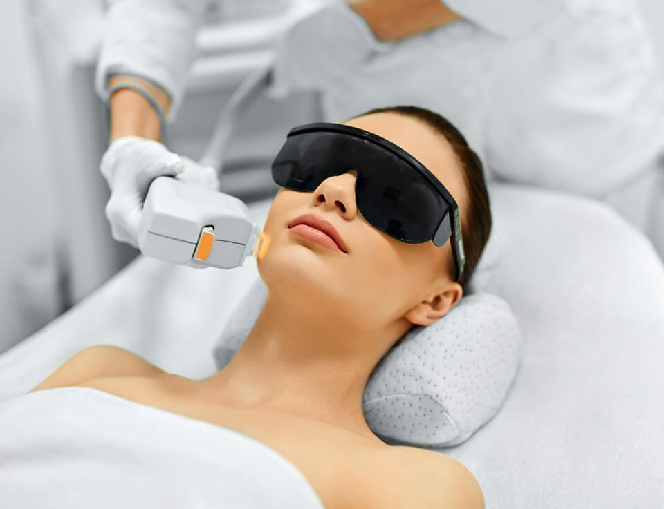 Picture of a female model patient undergoing a laser treatment on her face