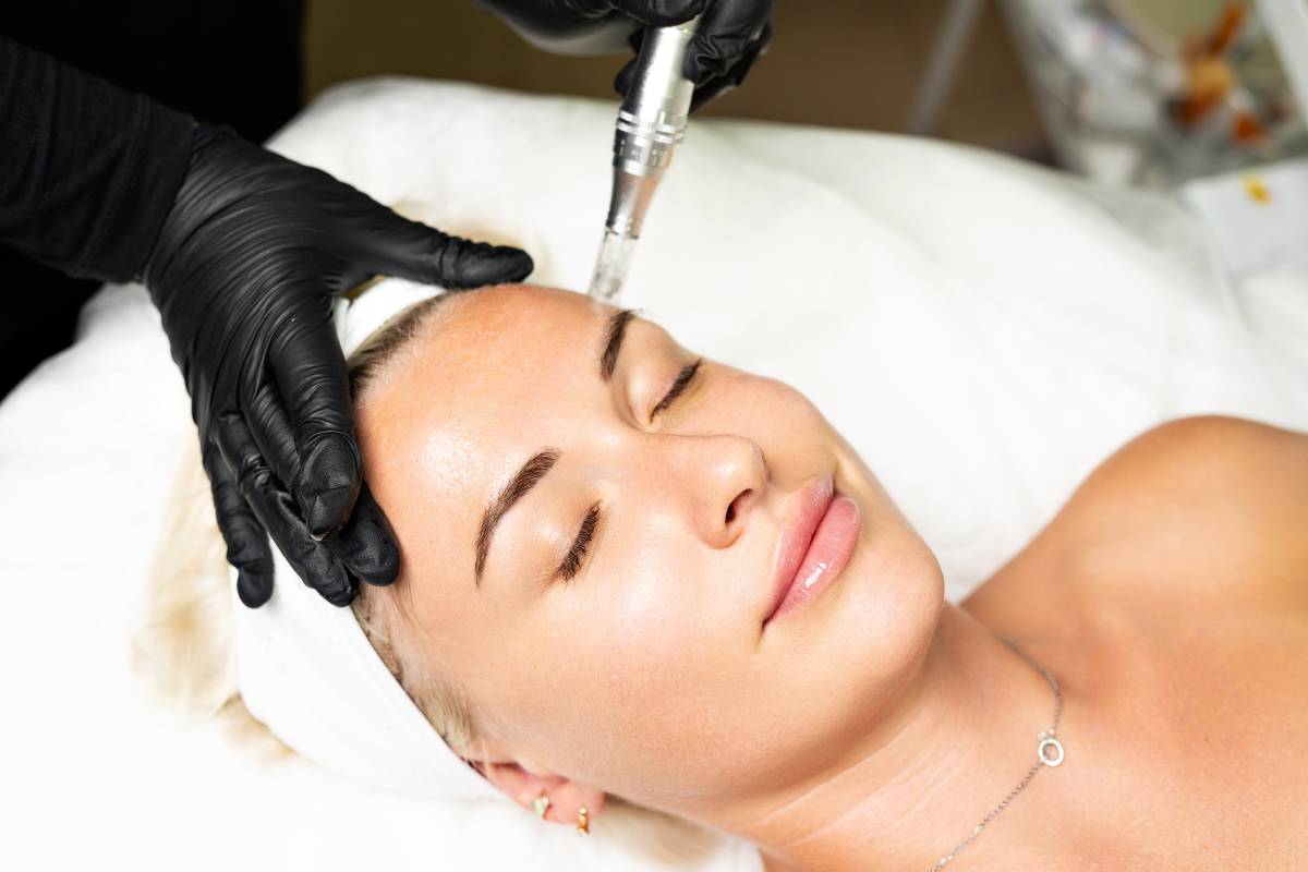 Cosmetologist performing a safe microneedling facial rejuvenation treatment.